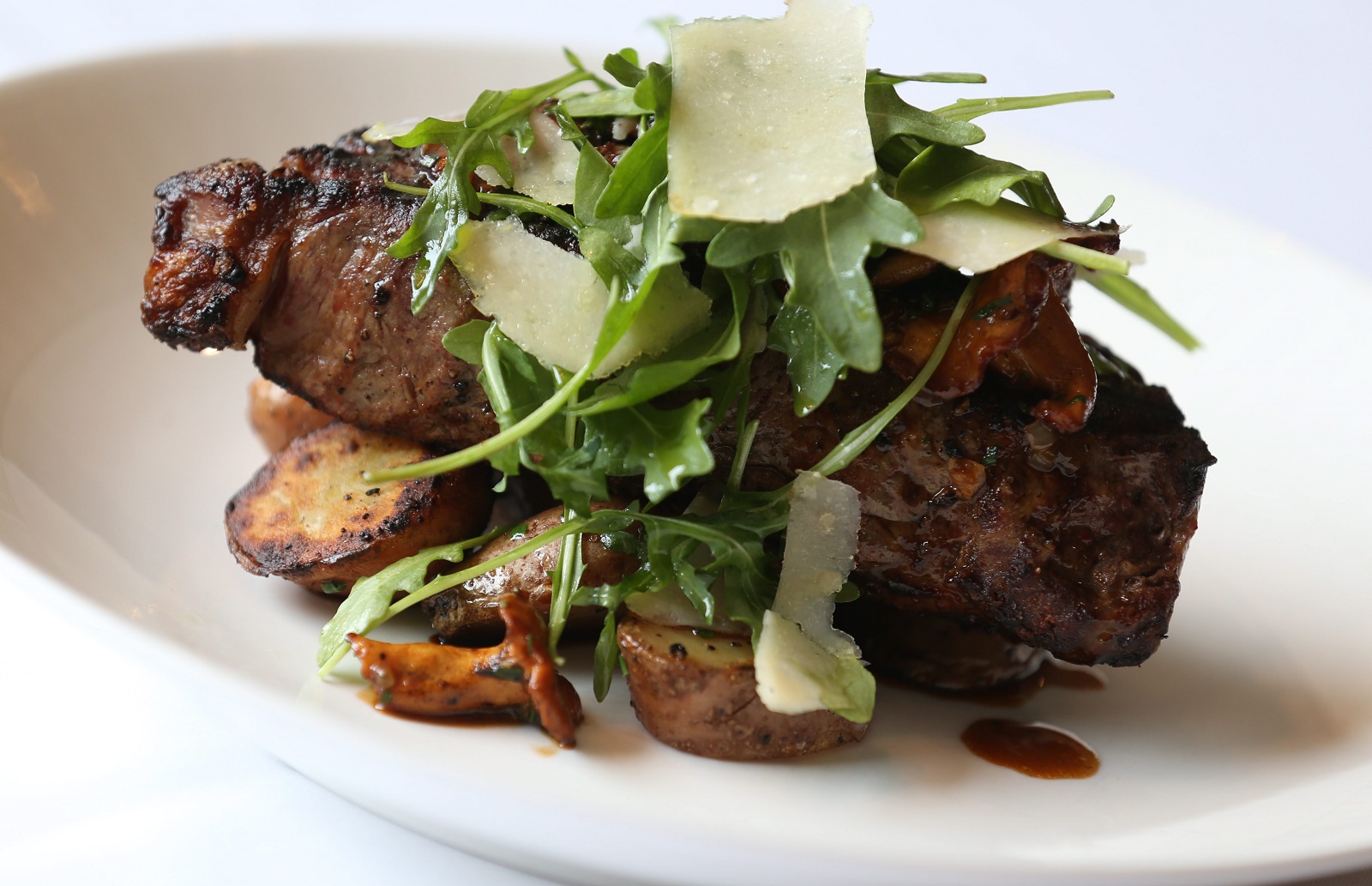 Tempo Restaurant is located at 581 Delaware Ave. in Buffalo. This is the 28-day dry aged NY strip with fingerling potatoes, wild hedgehog mushrooms, arugula and parmesan. Photo taken, Wednesday, March 11, 2015. (Sharon Cantillon/Buffalo News)